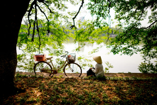 A woman relaxes along the edge of Hoan Kiem Lake in Hanoi, Vietnam on Saturday May 9th, 2015. Hoan Kiem Lake, meaning the "lake of the returned sword", is a popular attraction for both tourists and locals. 

Photo by Justin Mott For The New York Times
