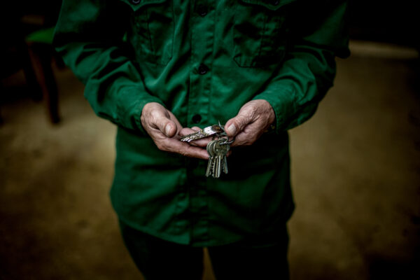 Dinh Van Tham, 61 years-old, pangolin keeper at SVW prepares his keys to check on the pangolins during his evening shift.