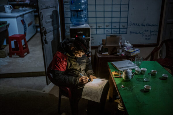 Pangolin keeper Dinh Van Tham, 61 years-old, logs information about the center’s 37 rescued pangolins after his nightly rounds.