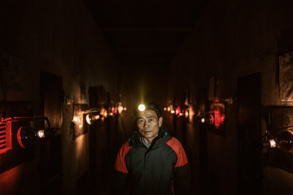 A portrait of pangolin caretaker Dinh Van Tham, 61, in the pangolin quarantine area of their rehabilitation center.