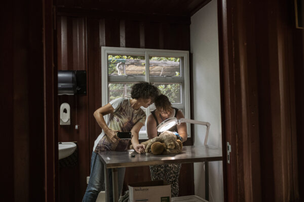 Monique Pool (left) and volunteer veterinarian Eva Scheltens check on a severely dehydrated sloth living nearby the rehabilitation center.