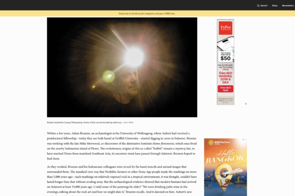 Scientist with a radiant sunburst light exploding behind his head in a dark background
